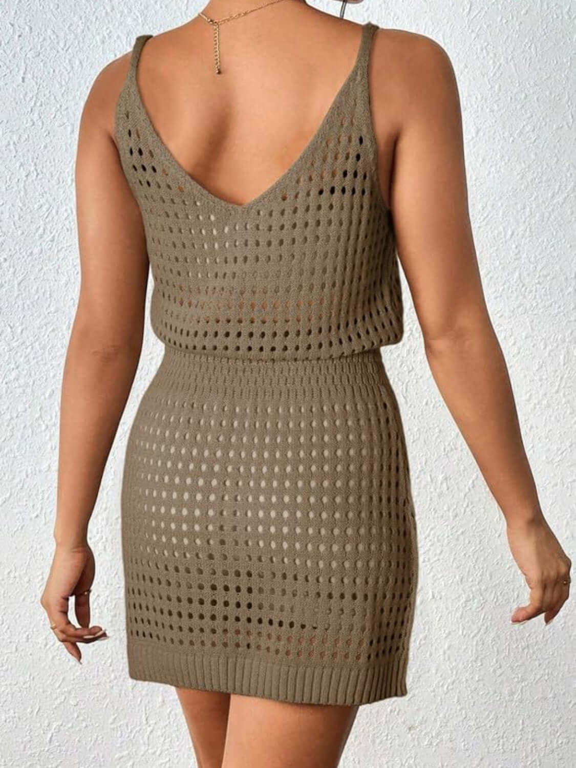 Woman wearing an Openwork V-Neck Sleeveless Cover Up Dress in khaki, showcasing its sheer and stretchy acrylic material from the back.