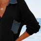 Stylish black openwork collared cover-up with denim pocket, perfect for beach outings on a sunny day.