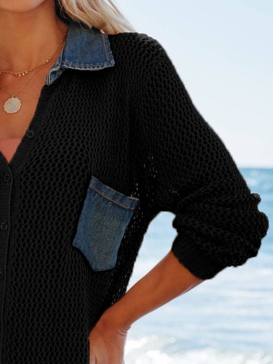 Stylish black openwork collared cover-up with denim pocket, perfect for beach outings on a sunny day.