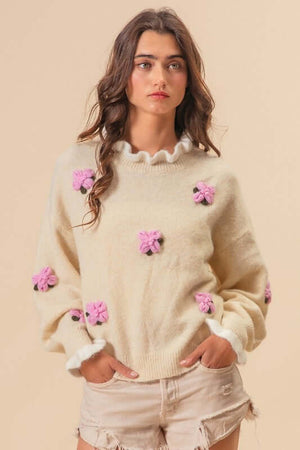 BiBi Ruffled Crochet Flower Sweater with pink embellishments, showcasing a relaxed dropped shoulder design. Perfect for effortless style!