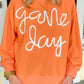 Woman wearing Bella Road Game Day Round Neck Long Sleeve Sweatshirt in orange with "Game Day" text