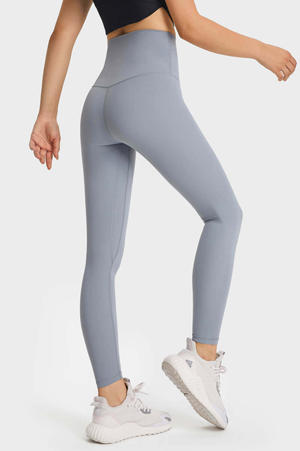 Woman in high waist, ultra soft blue leggings showcasing a comfy athleisure look paired with stylish sneakers.