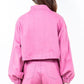 Back view of a pink cropped worker jacket with drawstring hem and balloon sleeves, paired with matching pants.