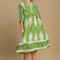 Umgee printed notched midi dress in green with white floral patterns, perfect for casual and semi-formal occasions.