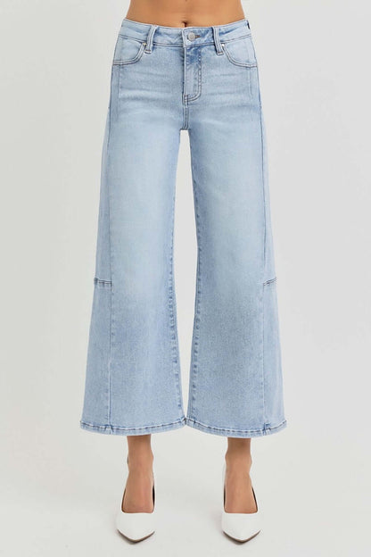 Risen full size high rise seamed detail wide leg crop jeans in light denim, shown with white heels for a chic and versatile look.