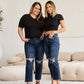 Models wearing RFM Tummy Control Distressed High Waist Raw Hem Jeans in a living room setting