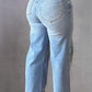 Woman wearing rhinestone straight jeans with pockets, back view. Featuring 75% cotton, 23% polyester, 2% elastane. Ready for stylish outings!