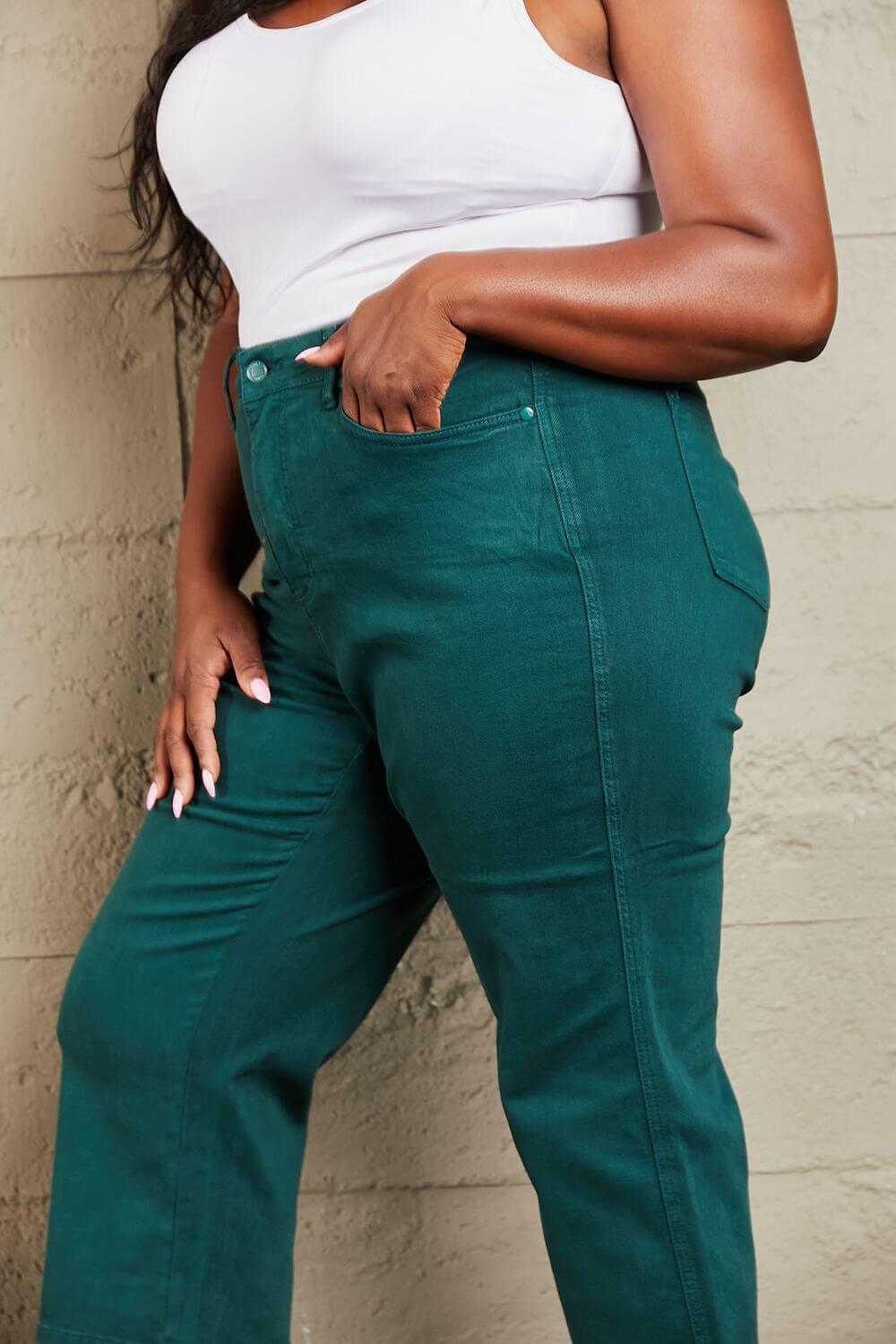 Woman wearing Hailey Full Size Tummy Control High Waisted Cropped Wide Leg Jeans in rich teal by Judy Blue Jeans.