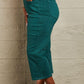 Woman wearing Hailey Full Size Tummy Control High Waisted Cropped Wide Leg Judy Blue Jeans in teal with white sandals