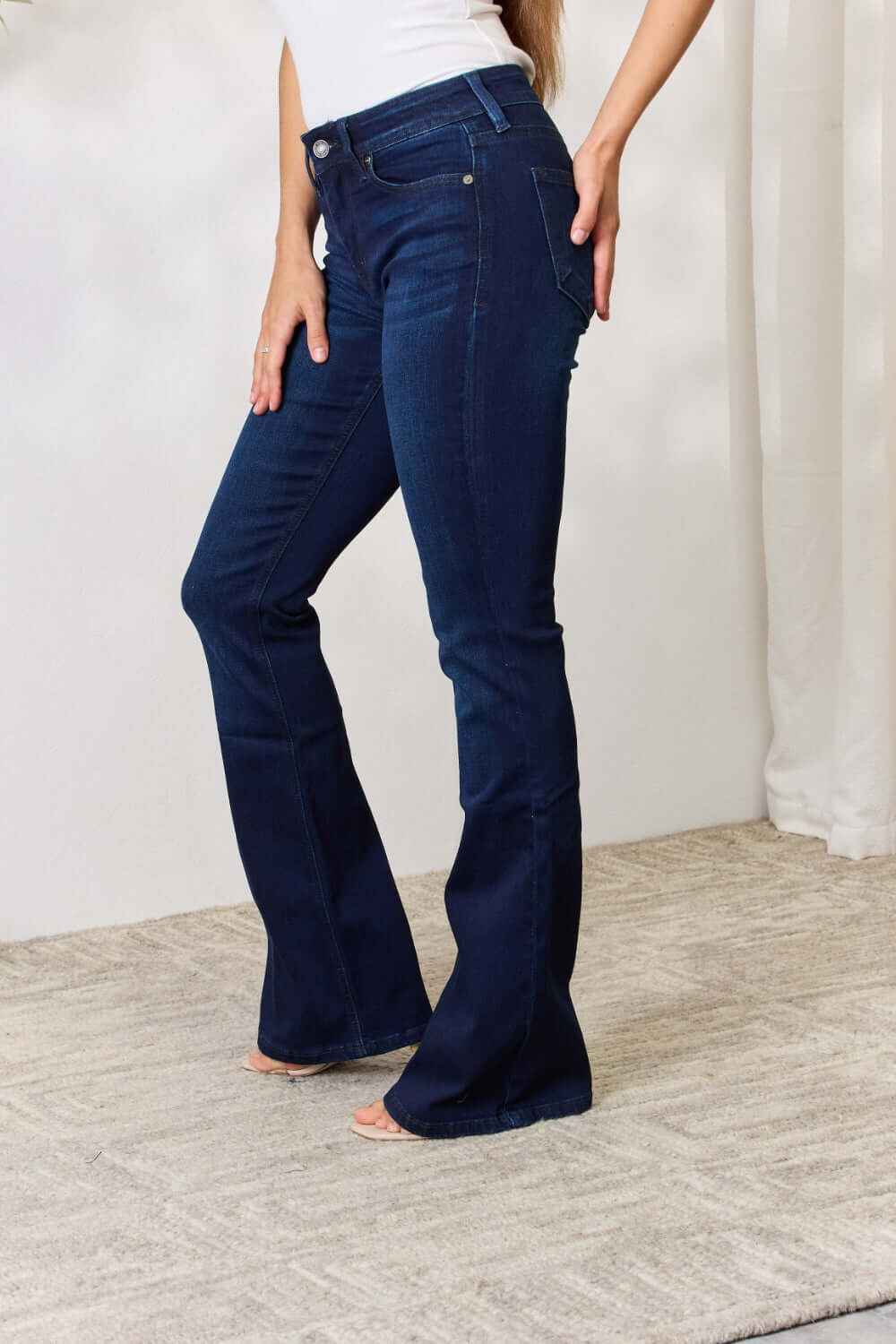 Woman wearing mid-rise flare jeans with a clean, non-distressed look, perfect for a versatile wardrobe staple.