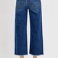 Back view of RISEN raw hem wide leg jeans showcasing stylish buckle details and a relaxed fit.