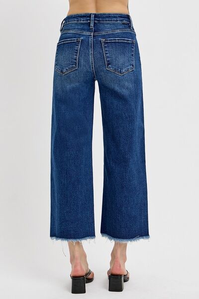 Back view of RISEN raw hem wide leg jeans showcasing stylish buckle details and a relaxed fit.