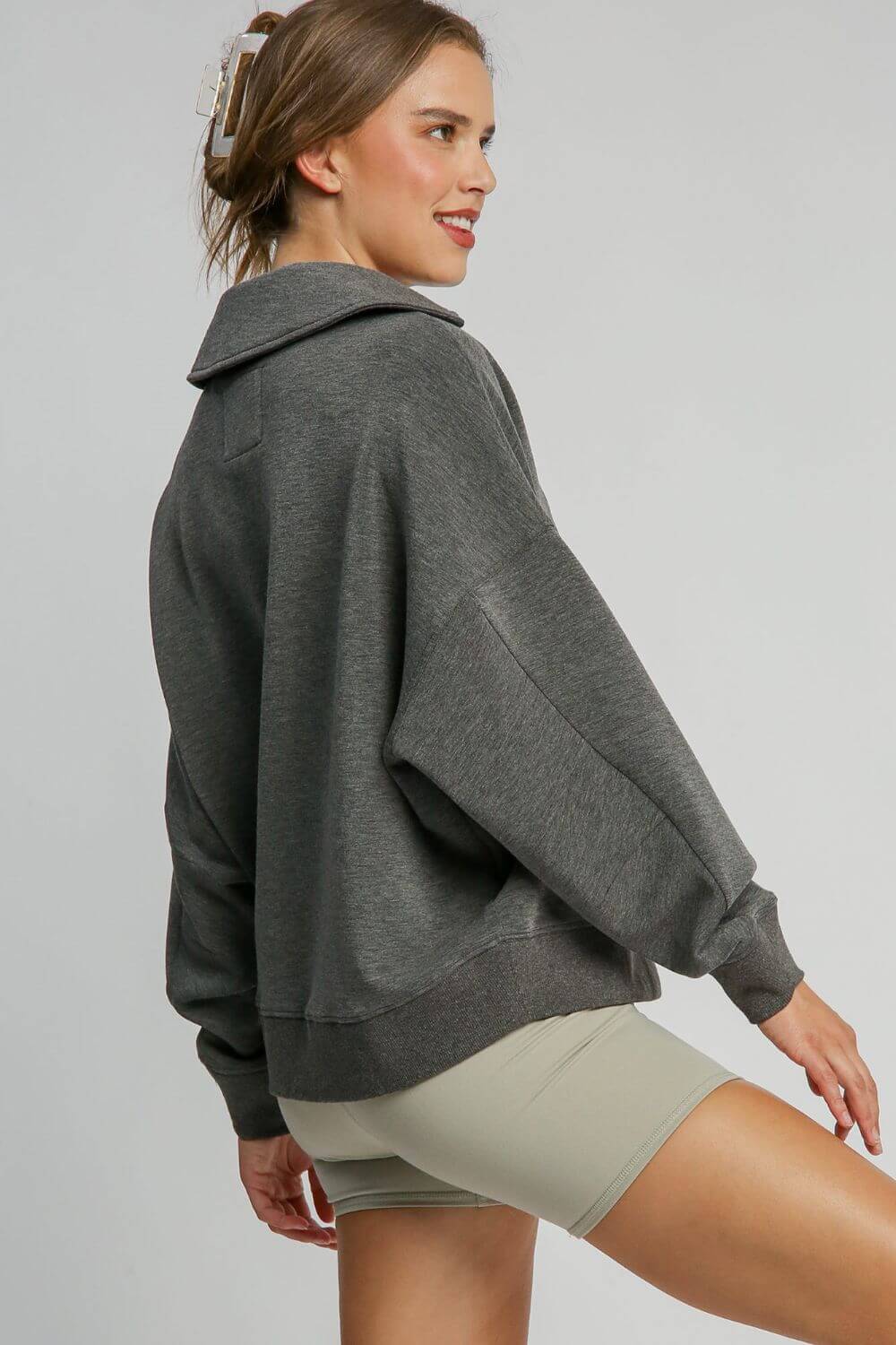 Stylish woman in a gray Johnny Collar Dropped Shoulder Sweatshirt, showcasing a relaxed fit and trendy design.