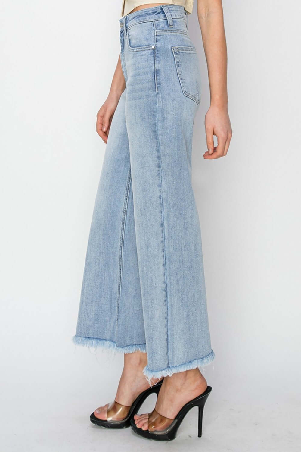 Trendy high rise crop wide fray hem jeans with flattering silhouette and relaxed fit, perfect for fashion-forward looks.