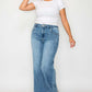 Woman wearing bytos high rise wide leg jeans with pockets, styled with a simple white t-shirt in a light blue color.