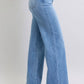 Judy Blue full-size wide leg jeans with pockets, showcasing a relaxed, vintage-inspired fit and stylish high-heeled shoes.