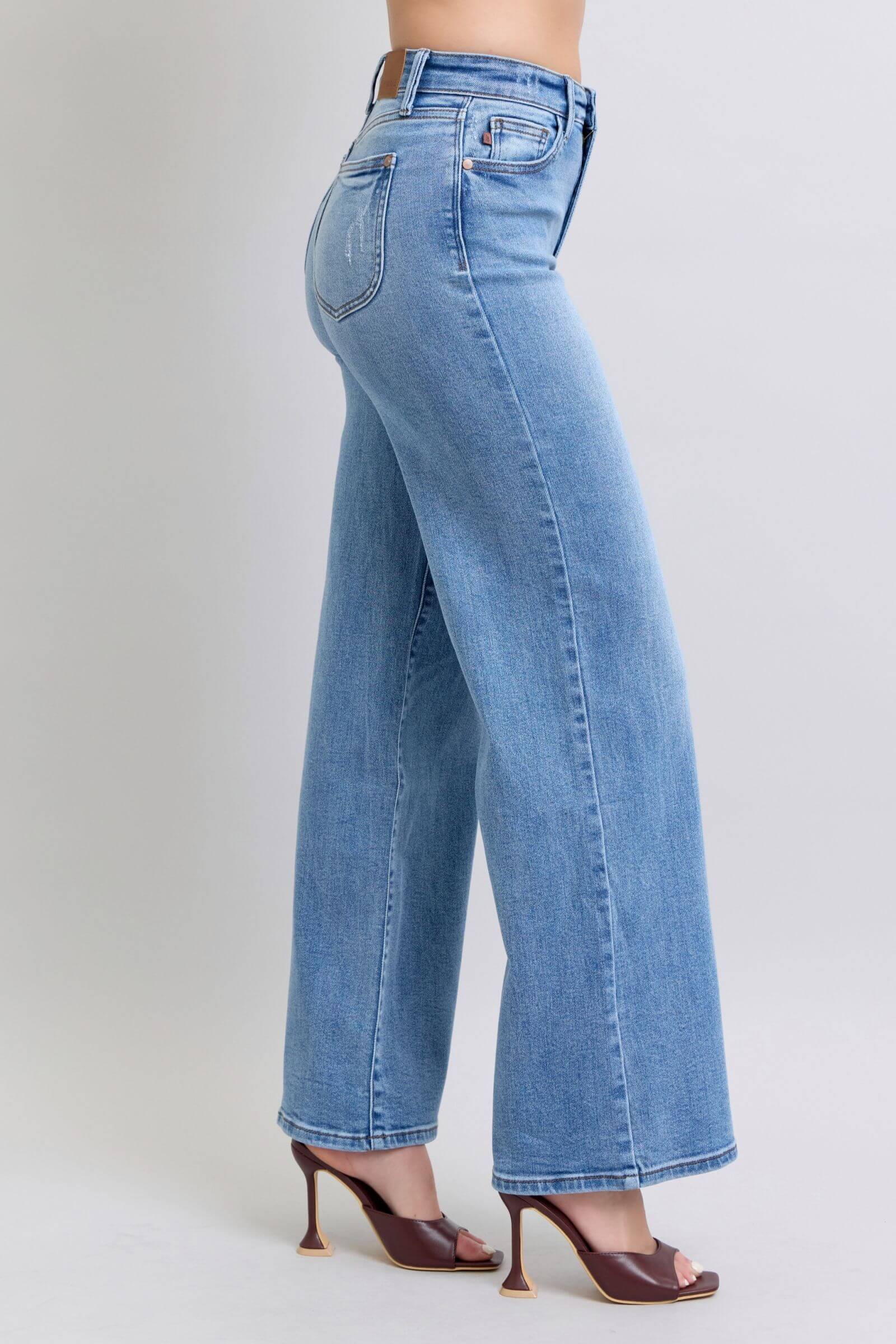 Judy Blue full-size wide leg jeans with pockets, showcasing a relaxed, vintage-inspired fit and stylish high-heeled shoes.