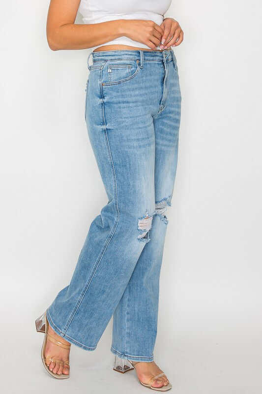 Woman showcasing bytos Full Size Distressed High Rise Straight Jeans with edgy rips and a flattering fit.