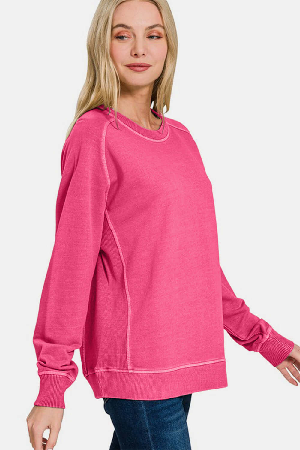 Model showcasing a pink Zenana Pigment Dyed French Terry Sweatshirt, perfect for casual wear and comfort.