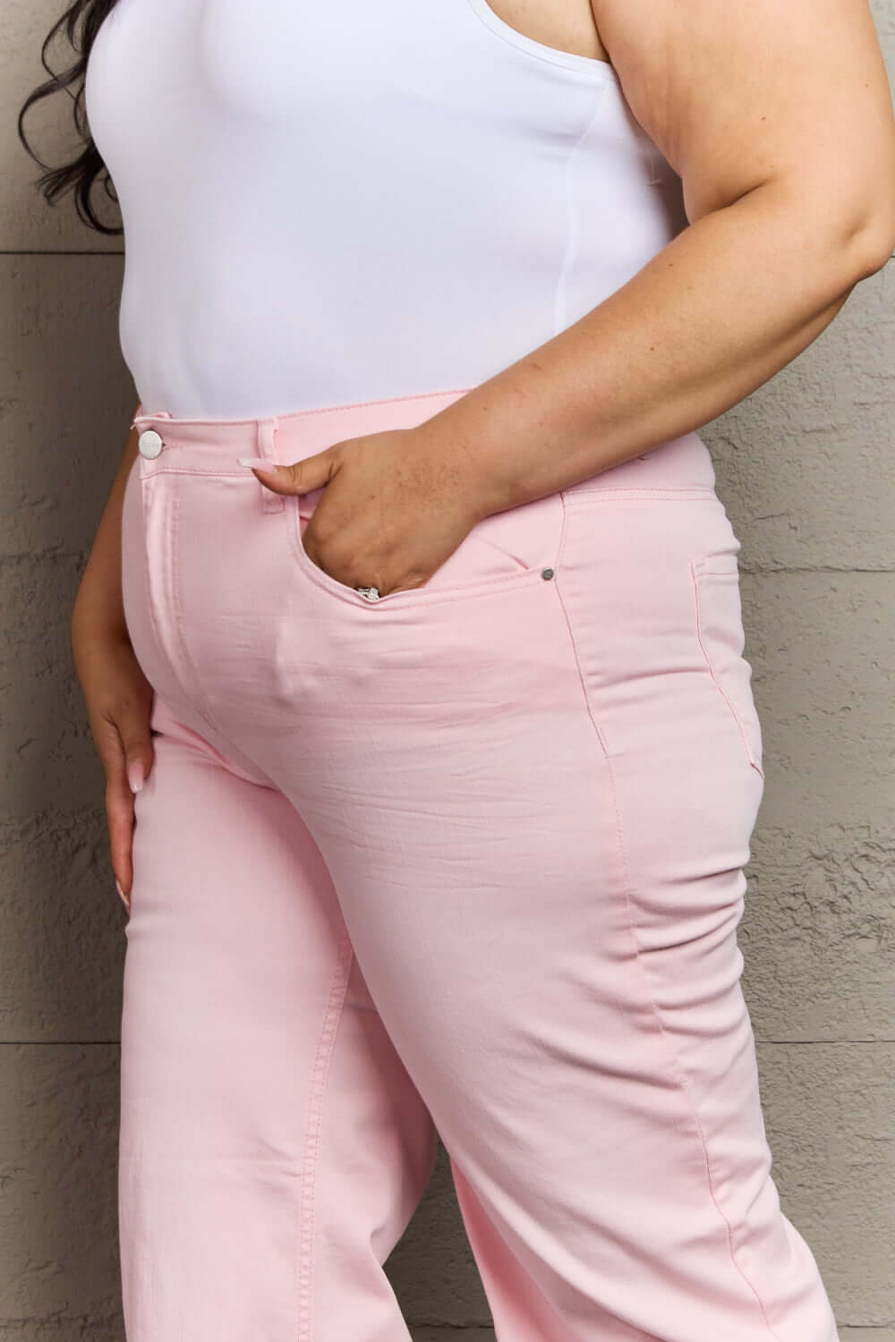 Woman wearing Raelene High Waist Wide Leg Jeans in Light Pink by Risen Jeans, showcasing chic and comfortable fit.