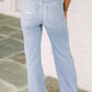 Back view of distressed high waist jeans featuring slightly stretchy fabric, perfect fit, and stylish detailing.