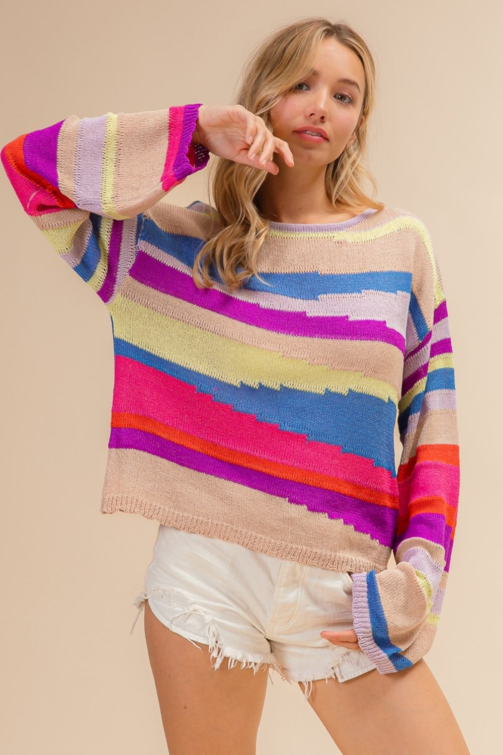 Woman wearing BiBi Multi Color Geometric Stripe Sweater, showcasing vibrant and trendy design, perfect for cozy, chic style.