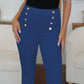 Woman wearing FAM-FAM High Waist Skinny Pants in blue with decorative buttons, perfect for chic style.