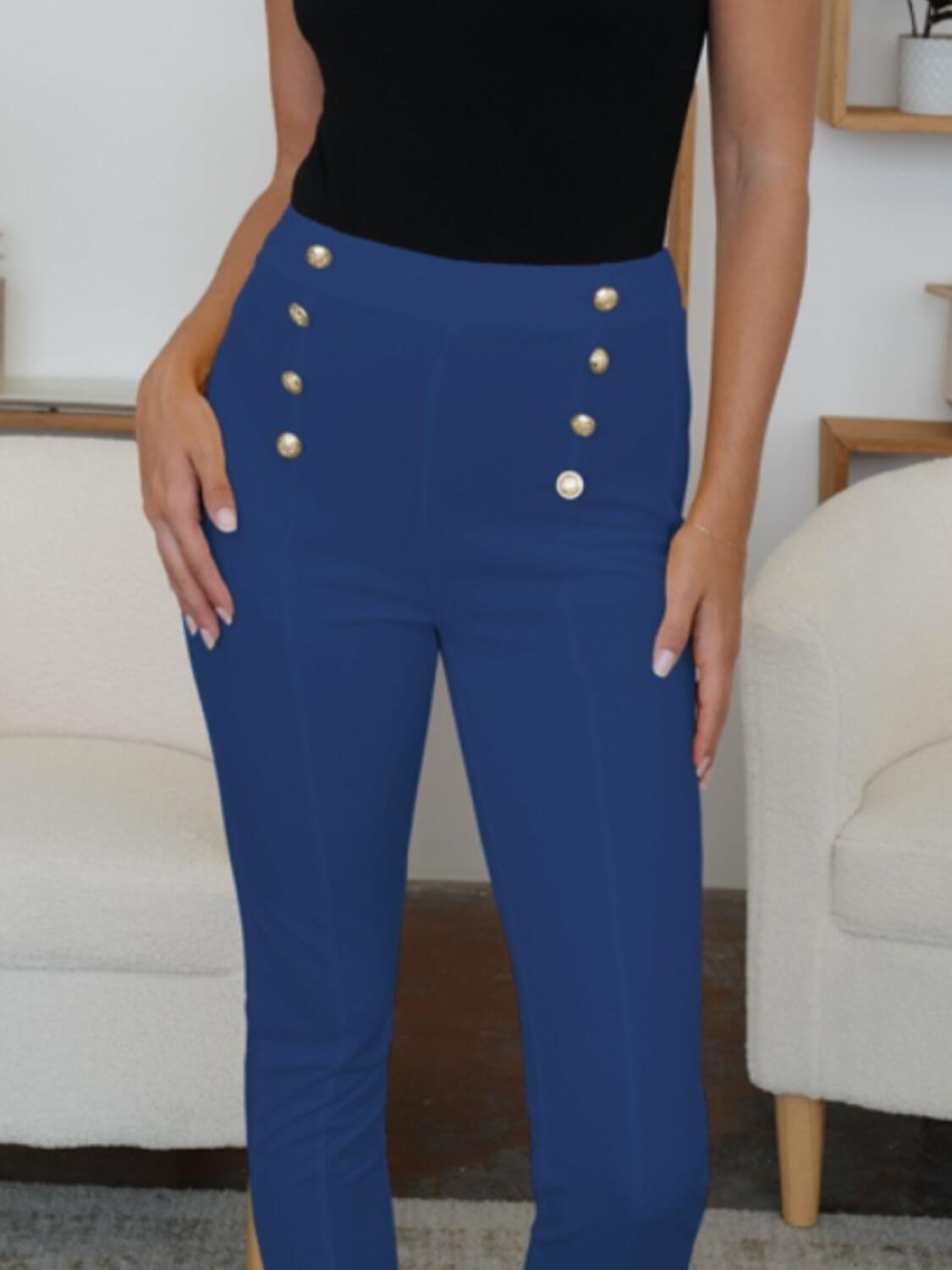 Woman wearing FAM-FAM High Waist Skinny Pants in blue with decorative buttons, perfect for chic style.