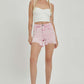 High-rise distressed denim shorts by Risen Jeans styled with a white crop top and black heels for a chic summer look.