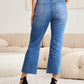 Woman wearing Mini Mia Full Size Tummy Control High Waist Jeans | Petite by RFM Jeans, showing back view in a stylish setting