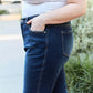 Woman wearing slim bootcut jeans with pocket detail on a casual outing.