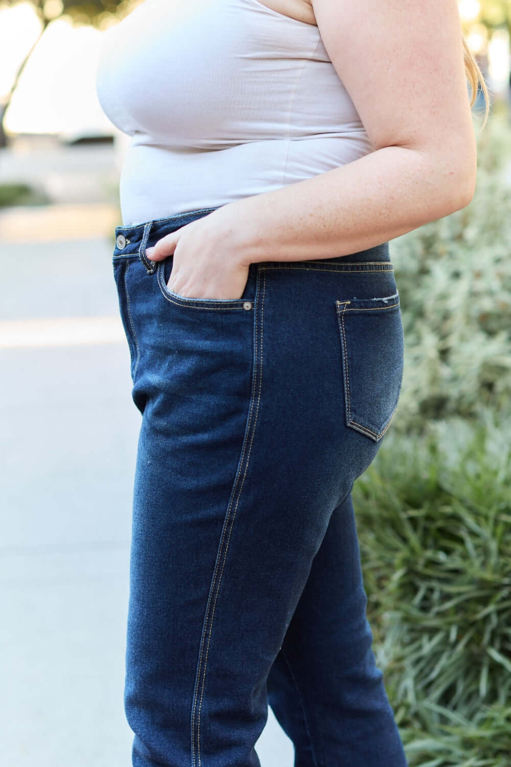 Woman wearing slim bootcut jeans with pocket detail on a casual outing.