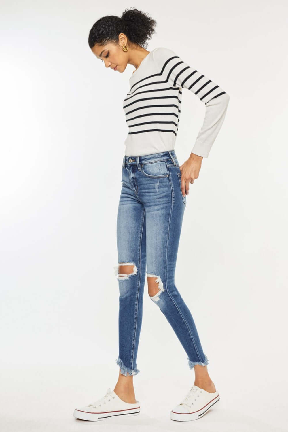 High Waist Distressed Raw Hem Ankle Skinny Jeans with playful cropped length and rebellious detailing, paired with casual striped sweater and sneakers