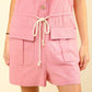 Half Button Drawstring Sleeveless Romper in pink with adjustable waist and front pockets, perfect for casual and trendy summer outfits.