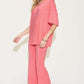 Woman wearing a pink Bamboo Drop Shoulder T-Shirt and Flare Pants Set featuring a basic style, made from bamboo fiber and spandex.