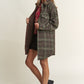 Stylish woman in J.NNA snap-down tweed plaid longline shacket, perfect for fall layering and modern comfort.