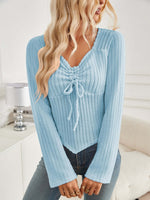 Woman wearing Bella Road ribbed drawstring long sleeve light blue T-shirt with slightly stretchy material, paired with jeans.