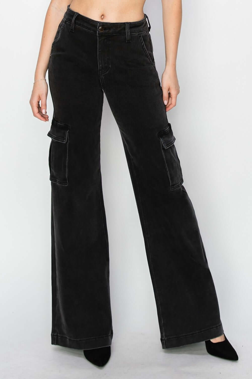 Woman showcasing high-rise wide leg cargo jeans by Risen Jeans with functional pockets and an edgy, urban style.