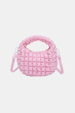 Pink quilted puffy crossbody bag with removable strap, fashion accessory, small size, polyester material.