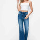 Model in white crop top wearing bytos high rise bootcut jeans with pockets, showcasing a stylish and flattering fit.