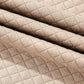 Close-up of quilted fabric texture in beige from Bella Road round neck long sleeve top and shorts set.