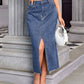 Woman wearing Bella Road Slit Midi Denim Skirt with Pockets, paired with a white top, standing on steps. Stylish and versatile fashion.