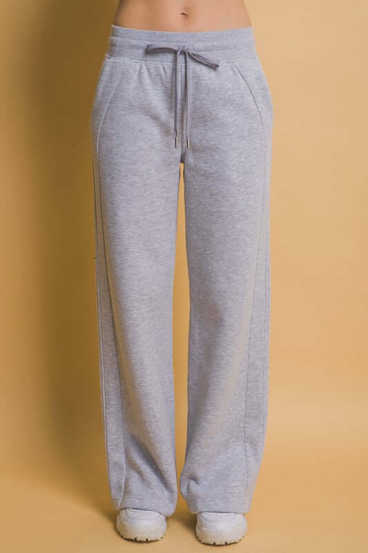 Grey drawstring wide leg sweatpants with pockets, perfect for loungewear or casual outings.