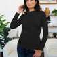 Woman wearing a black FAM-FAM ruched mock neck long sleeve t-shirt, perfect for fall layering and style.