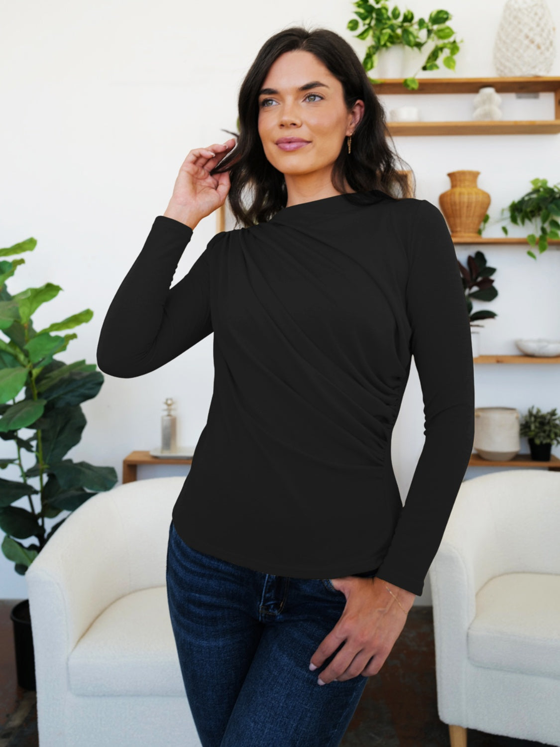 Woman wearing a black FAM-FAM ruched mock neck long sleeve t-shirt, perfect for fall layering and style.