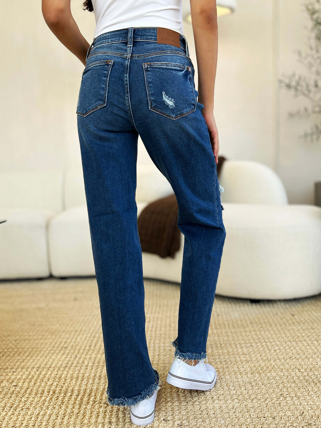 Full Size Mid Rise Distressed Raw Hem Jeans by Judy Blue, showcasing stylish back view with raw hem and distressed detailing