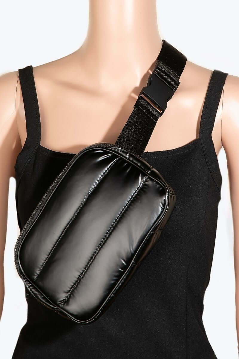 Sleek black quilted nylon crossbody bag displayed on a mannequin, showcasing its practical and stylish design.