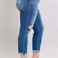 Judy Blue plus size button fly distressed jeans featuring pockets and stylish ripped details, perfect for casual wear.