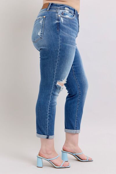 Judy Blue plus size button fly distressed jeans featuring pockets and stylish ripped details, perfect for casual wear.