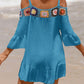 Woman wearing a blue crochet cold shoulder three-quarter sleeve cover-up on the beach